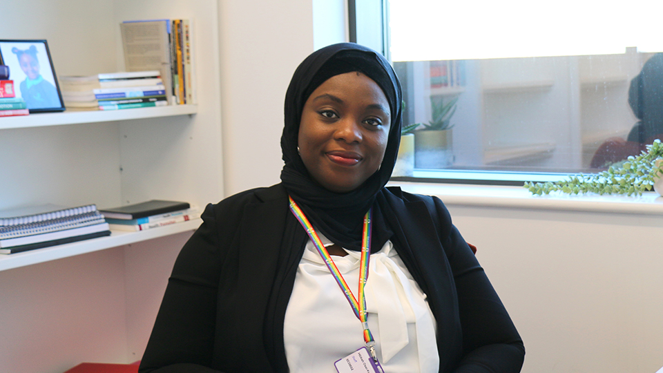 hibbah sitting at her desk in her office
